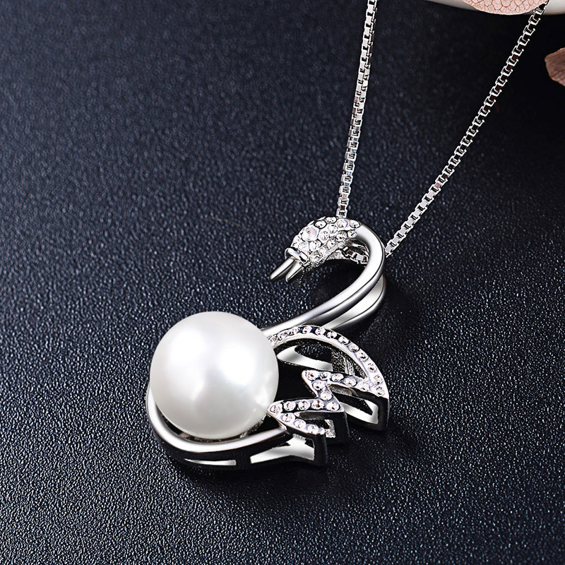 Delicate silver swan necklace with pearl pendant